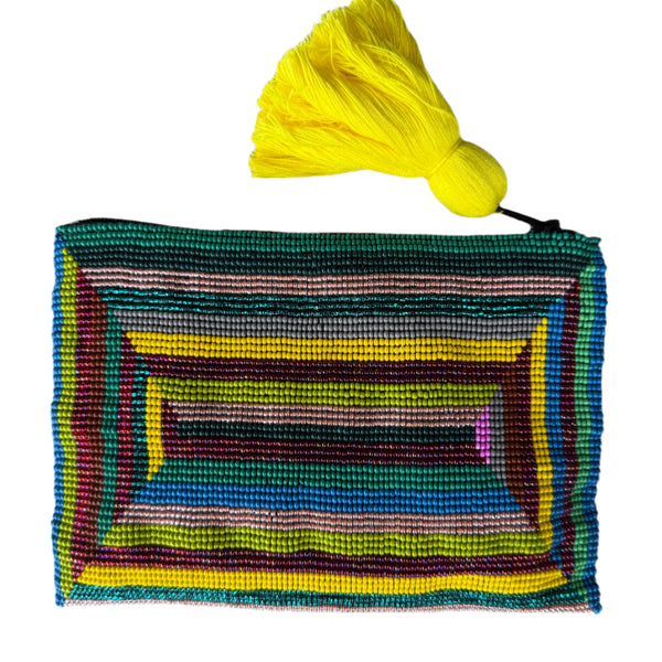 Colorful woven pouch with a yellow tassel on a gray background